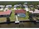 Aerial view of waterfront home with a private dock and screened-in pool at 612 Macedonia Dr, Punta Gorda, FL 33950