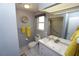 Modern bathroom with single vanity, tiled floors and updated shower at 612 Macedonia Dr, Punta Gorda, FL 33950