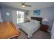 Comfortable bedroom with carpet flooring, ceiling fan, turtle art, and natural light at 612 Macedonia Dr, Punta Gorda, FL 33950