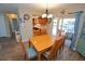 Dining area with hardwood floors, a wooden table and chairs, and sliding glass doors to the outside at 612 Macedonia Dr, Punta Gorda, FL 33950