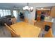 Dining area with hardwood floors, a wooden table and chairs, and open access to the kitchen and living room at 612 Macedonia Dr, Punta Gorda, FL 33950