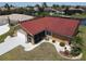 Attractive single-story home boasting lush landscaping, a clay tile roof, and an attached garage at 612 Macedonia Dr, Punta Gorda, FL 33950
