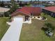 Inviting single-story home featuring a red roof, screened entryway and attached garage with a well-maintained lawn at 612 Macedonia Dr, Punta Gorda, FL 33950