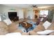 Spacious living room with hardwood floors, comfortable seating, and an open layout to the dining area at 612 Macedonia Dr, Punta Gorda, FL 33950