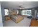 Bright primary bedroom with stylish furnishings, view of pool and waterfront at 612 Macedonia Dr, Punta Gorda, FL 33950