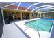 Inviting screened-in pool area with plenty of lounge seating and clear blue water at 612 Macedonia Dr, Punta Gorda, FL 33950