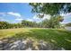 A spacious backyard with lawn and mature trees at 654 Aqui Esta Dr, Punta Gorda, FL 33950