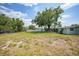 A grassy backyard provides space for outdoor activities at 654 Aqui Esta Dr, Punta Gorda, FL 33950