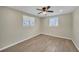 Bright, airy bedroom with wood look tile floors, ceiling fan, and plenty of natural light at 654 Aqui Esta Dr, Punta Gorda, FL 33950