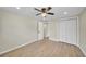Comfortable bedroom with wood-look tile flooring, a ceiling fan, and closet space at 654 Aqui Esta Dr, Punta Gorda, FL 33950