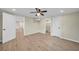Wood-look tile bedroom with a ceiling fan; doorways lead to other rooms and a bathroom at 654 Aqui Esta Dr, Punta Gorda, FL 33950