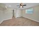 Cozy bedroom with wood-look tile, ceiling fan, and doorways to closet and other rooms at 654 Aqui Esta Dr, Punta Gorda, FL 33950