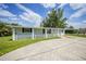 An exterior view of the home showcasing the front yard and driveway at 654 Aqui Esta Dr, Punta Gorda, FL 33950