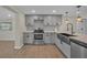 Updated kitchen featuring new stainless steel appliances, modern finishes, and hardwood floors at 654 Aqui Esta Dr, Punta Gorda, FL 33950