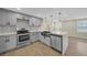 Modern kitchen with stainless appliances, sleek countertops, and stylish backsplash detail at 654 Aqui Esta Dr, Punta Gorda, FL 33950