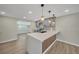 Well-lit kitchen featuring stainless steel appliances, an island bar, and hardwood flooring at 654 Aqui Esta Dr, Punta Gorda, FL 33950