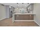 Modern kitchen with stainless appliances, a large island, and hardwood floors throughout at 654 Aqui Esta Dr, Punta Gorda, FL 33950