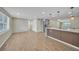 Open living space with hardwood floors leading to the kitchen with stainless steel appliances at 654 Aqui Esta Dr, Punta Gorda, FL 33950