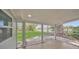 A screened porch with wood floors provides an outdoor space to enjoy the backyard views at 654 Aqui Esta Dr, Punta Gorda, FL 33950
