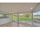 A screened porch provides an outdoor space to enjoy the views of the lawn at 654 Aqui Esta Dr, Punta Gorda, FL 33950