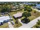 Aerial view of a home with a large, green yard and mature trees, near a waterfront community at 661 Athos Ter, Port Charlotte, FL 33952