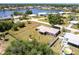 Aerial view of the property with a sprawling lawn, mature trees, and easy access to the waterfront at 661 Athos Ter, Port Charlotte, FL 33952