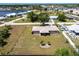 Aerial view of home with a large yard and mature landscaping, located near shopping and dining at 661 Athos Ter, Port Charlotte, FL 33952