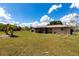 Large backyard with a well-maintained lawn and tropical landscaping, perfect for outdoor activities at 661 Athos Ter, Port Charlotte, FL 33952
