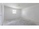 A bright, empty bedroom features a window that provides ample natural light at 661 Athos Ter, Port Charlotte, FL 33952