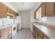 Functional kitchen with tile flooring, wood cabinets, white appliances and plenty of counter space at 661 Athos Ter, Port Charlotte, FL 33952