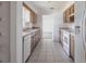 Clean kitchen featuring tile flooring, plenty of wood cabinets, and white appliances at 661 Athos Ter, Port Charlotte, FL 33952