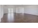 Minimalist living room featuring wood-look flooring and a sliding glass door leading to the outdoors at 661 Athos Ter, Port Charlotte, FL 33952
