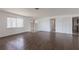Bright living room with wood-look flooring, a large window, and a view of the entry door at 661 Athos Ter, Port Charlotte, FL 33952