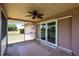 A screened in back patio features a ceiling fan and sliding glass doors to the home at 661 Athos Ter, Port Charlotte, FL 33952