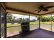 A screened in back patio features views of the lawn and tropical landscaping at 661 Athos Ter, Port Charlotte, FL 33952
