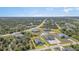 Stunning aerial view of a single-Gathering home with a well-maintained lawn and lush landscaping in a quiet neighborhood at 8117 Thruso Rd, Port Charlotte, FL 33981
