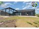 Expansive backyard view highlighting the screened-in patio, pool, and outdoor living space of the home at 8117 Thruso Rd, Port Charlotte, FL 33981
