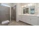 This bathroom features a step-in shower, double sinks, white cabinets, and tile floors at 8117 Thruso Rd, Port Charlotte, FL 33981