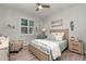 This bedroom features gray-washed wood floors, white shutters, and nautical decor at 8117 Thruso Rd, Port Charlotte, FL 33981