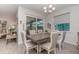 This dining room features a chandelier, tile floors, a sliding glass door, and neutral walls at 8117 Thruso Rd, Port Charlotte, FL 33981