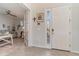This entryway features tile floors, neutral walls, a white door, and a view into the living room at 8117 Thruso Rd, Port Charlotte, FL 33981