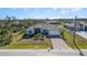 Charming single-story home with well-manicured lawn, mature landscaping, and a brick driveway at 8117 Thruso Rd, Port Charlotte, FL 33981