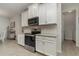 Modern kitchen with white cabinets, subway tile backsplash, and stainless steel appliances at 8117 Thruso Rd, Port Charlotte, FL 33981