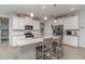 Bright kitchen featuring white cabinets, stainless steel appliances, and a granite countertop island with barstool seating at 8117 Thruso Rd, Port Charlotte, FL 33981