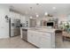 Stylish kitchen with a central island, stainless steel appliances, and an inviting adjacent living area at 8117 Thruso Rd, Port Charlotte, FL 33981