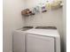 This laundry room features a side-by-side washer and dryer and a wire rack at 8117 Thruso Rd, Port Charlotte, FL 33981