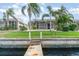 Waterfront property with lush lawn and enclosed pool area with private dock at 814 Via Tripoli, Punta Gorda, FL 33950