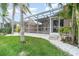 Tropical backyard and pool area with lush landscaping and screened enclosure at 814 Via Tripoli, Punta Gorda, FL 33950