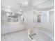 Bright Primary bathroom featuring white cabinets, shower, and soaking tub at 814 Via Tripoli, Punta Gorda, FL 33950