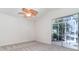 Spacious bedroom with ceiling fan and sliding glass doors to the screened patio at 814 Via Tripoli, Punta Gorda, FL 33950